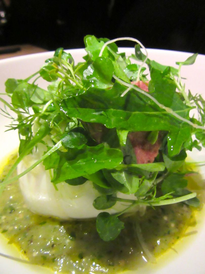A buxomy pillow of burrata smothered in “weeds” explodes its creamy corps –enough for the table.