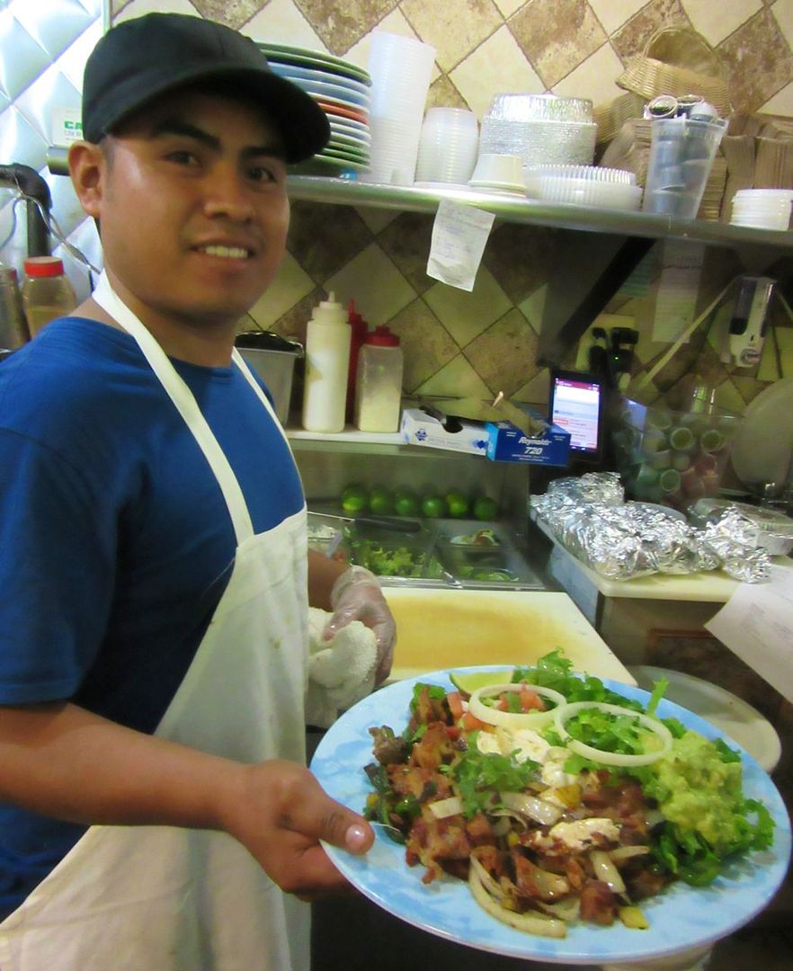 Our waiter at Taqueria y Fonda is poised to deliver our Alhambre, a gluttonous mish-mash.