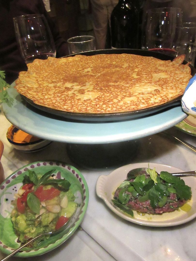 Chickpea crepes come in an iron pan on a cake stand to tear off and stuff with a choice of saucers.